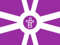 Flag of the Nunavut region of the DRSBI. It has an inuksuk in the centre of a light purple version of the Regional Flag base. The inuksuk is found in the flag of Nunavut itself.