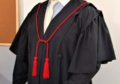 Example of the use of a red investiture cord, from the judiciary, on the robe of a judge of the Imperial Supreme Court